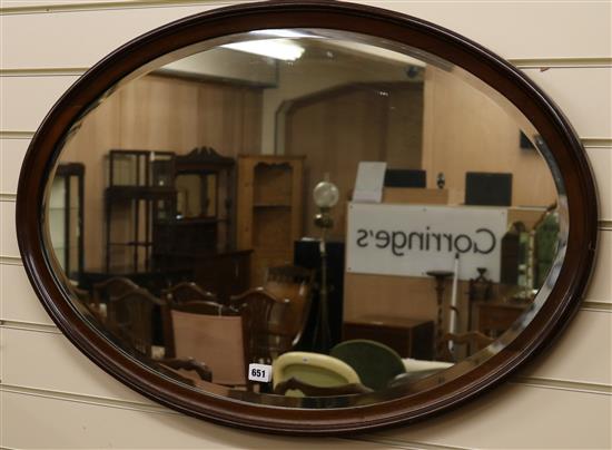 An oval mahogany framed mirror W.90cm